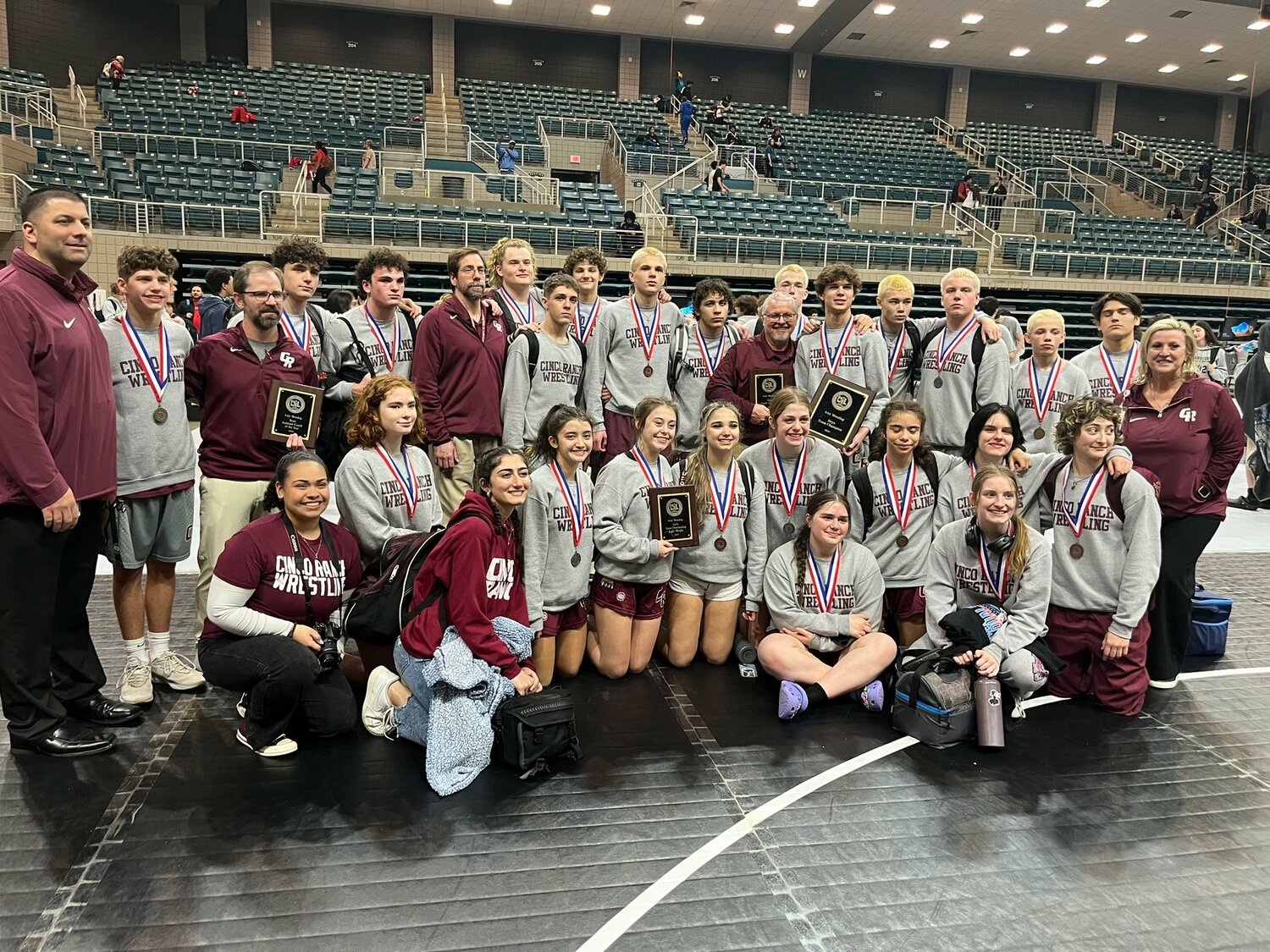 The Cinco Ranch boys and girls teams with their medals after the District 9-6A meet at the Merrell Center.